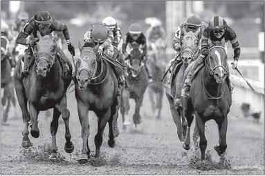 Mystik Dan, with Brian Hernandez Jr. up, right, wins the 150th running of the Kentucky Derby, in a three-way photo finish over second place Sierra Leone and third place Forever Young at Churchill Downs on Saturday, May 4, 2024, in Louisville, Kentucky. Alex Slitz | Lexington Herald-Leader | TNS
