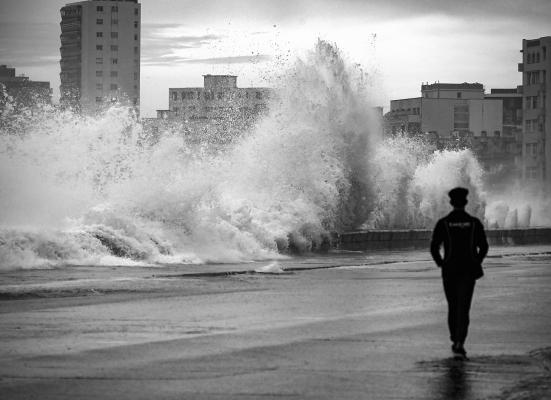 A man walks by the Malecon in Havana, on Sept. 28, 2022, after the passage of hurricane Ian. Cuba exceeded 12 hours this Wednesday in total blackout with “zero electricity generation” due to failures in the links of the national electrical system (sen), after the passage of powerful Hurricane Ian. (Yamil Lage/AFP via Getty Images/TNS)