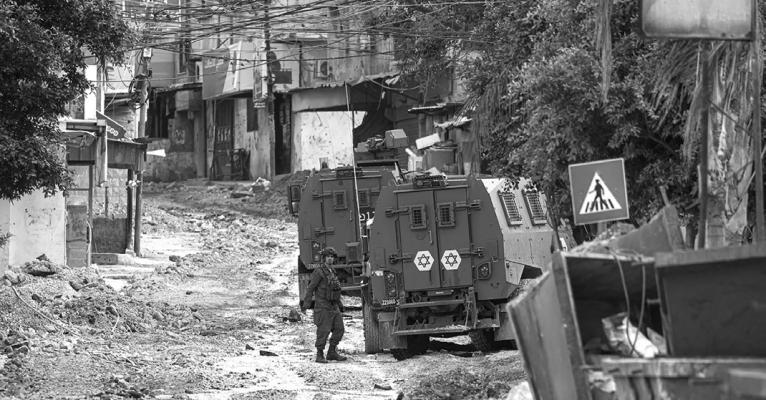 Israeli forces patrol a deserted road in Tulkarem during a raid on the occupied West Bank city on May 6, 2024. The Israeli army said troops killed five Palestinian militants barricaded in a building during a 12-hour siege in Tulkarem on May 5, 2024. The already restive West Bank has seen a surge in violence since the Israel-Hamas war erupted on Oct. 7. (Jaafar Ashtiyeh/AFP via Getty Images/TNS)
