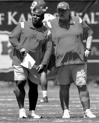 Offensive coordinator Eric Bieniemy and head coach Andy Reid observe players on the first day of the Kansas City Chiefs rookie minicamp earlier this month in Kansas City. Jill Toyoshiba | Kansas City Star | TNS