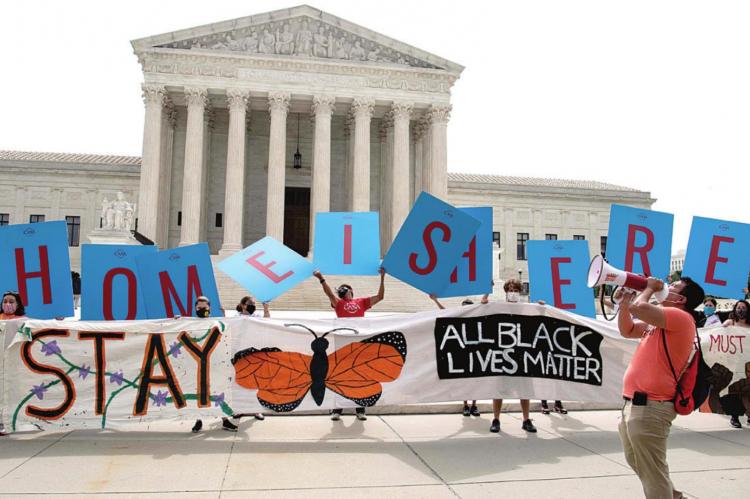 Activists hold a banner in front of the US Supreme Court in Washington, DC, on June 18, 2020. The US Supreme Court rejected President Donald Trump’s move to rescind the DACA program that offers protections to 700,000 undocumented migrants brought to the US as children. (Nicholas Kamm/AFP via Getty Images)