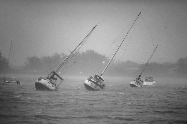 Sail boats anchored in Roberts Bay are blown around by 50 mph winds in Venice, Florida, as Hurricane Ian, a Category 5 Hurricane, approaches the West Coast of Florida, on Wednesday, Sept. 28, 2022. (Pedro Portal/ El Nuevo Herald/TNS)