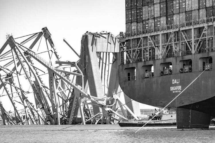 The wreckage of the Francis Scott Key Bridge is seen beyond the stern of the container ship Dali three weeks after the catastrophic collapse. (Jerry Jackson/The Baltimore Sun/TNS)