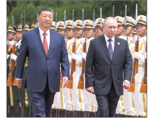 China's President Xi Jinping, left, and Russia's President Vladimir Putin, right, attend an official welcoming ceremony in front of the Great Hall of the People in Tiananmen Square, on May 16, 2024, in Beijing, China. (Mikhail Metzel/TASS/Zuma Press/TNS)