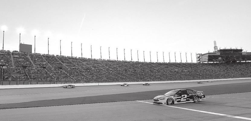 Monster Energy NASCAR Cup Series driver Brad Keselowski (2) pulls out of the pits as the sun sets during the KC Masterpiece 400 on May 12, 2018, at the Kansas Speedway in Kansas City, Kansas. John Sleezer | Kansas City Star | TNS