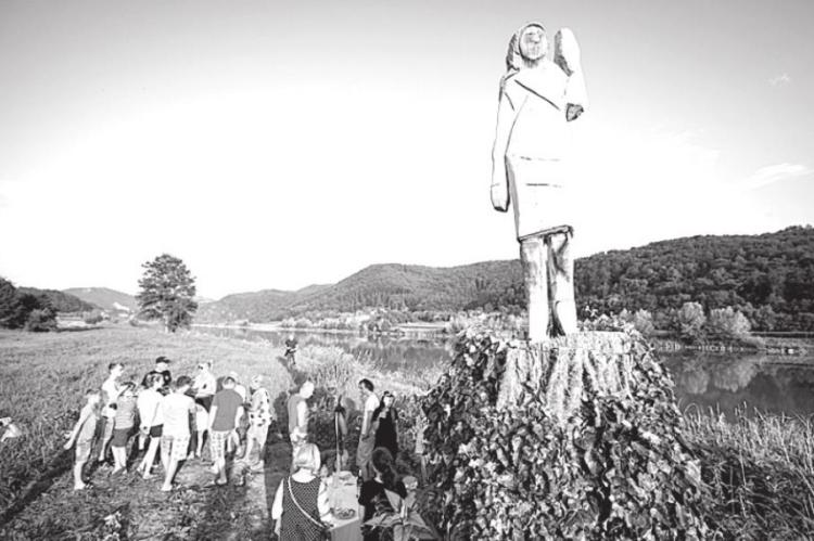 People gather around what conceptual artist Ales ‘Maxi’ Zupevc claims is the first ever monument of Melania Trump, set in the fields near the town of Sevnica, Slovenia, the U.S. first lady’s hometown, during an inauguration celebration on July 5, 2019. (Jure Makovec/AFP/Getty Images/TNS)