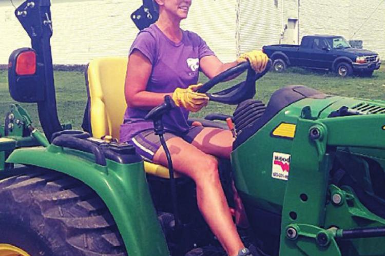 WOMEN CAN DRIVE TRACTORS, TOO — Jodi Hayse takes her turn on the tractor.