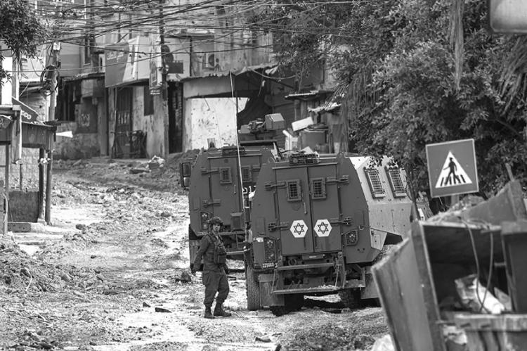 Israeli forces patrol a deserted road in Tulkarem during a raid on the occupied West Bank city on May 6, 2024. The Israeli army said troops killed five Palestinian militants barricaded in a building during a 12-hour siege in Tulkarem on May 5, 2024. The already restive West Bank has seen a surge in violence since the Israel-Hamas war erupted on Oct. 7. (Jaafar Ashtiyeh/AFP via Getty Images/TNS)